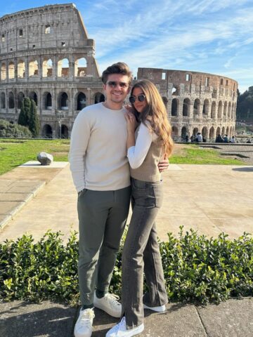 Couple in front of colosseum.